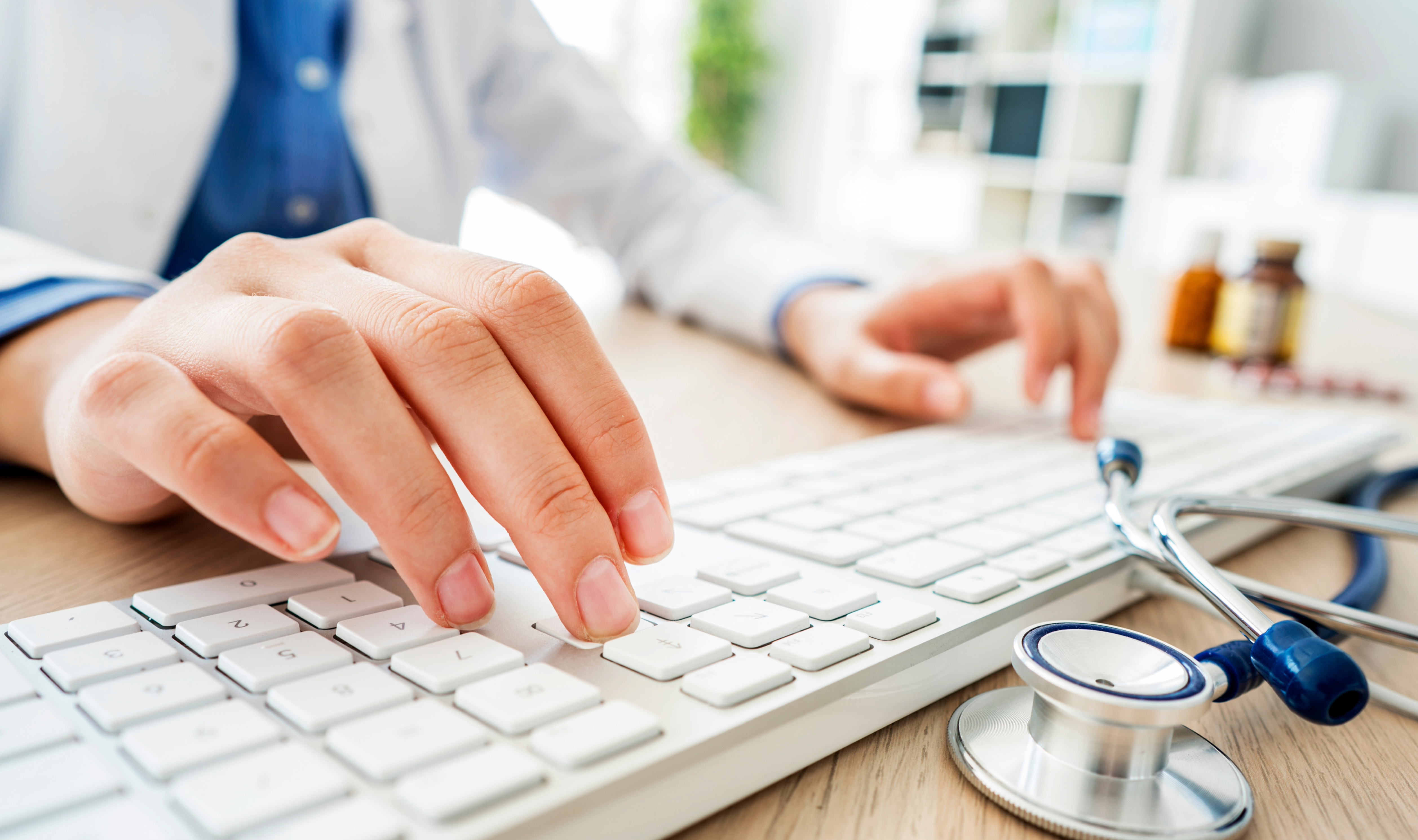 Doctor typing on a computer